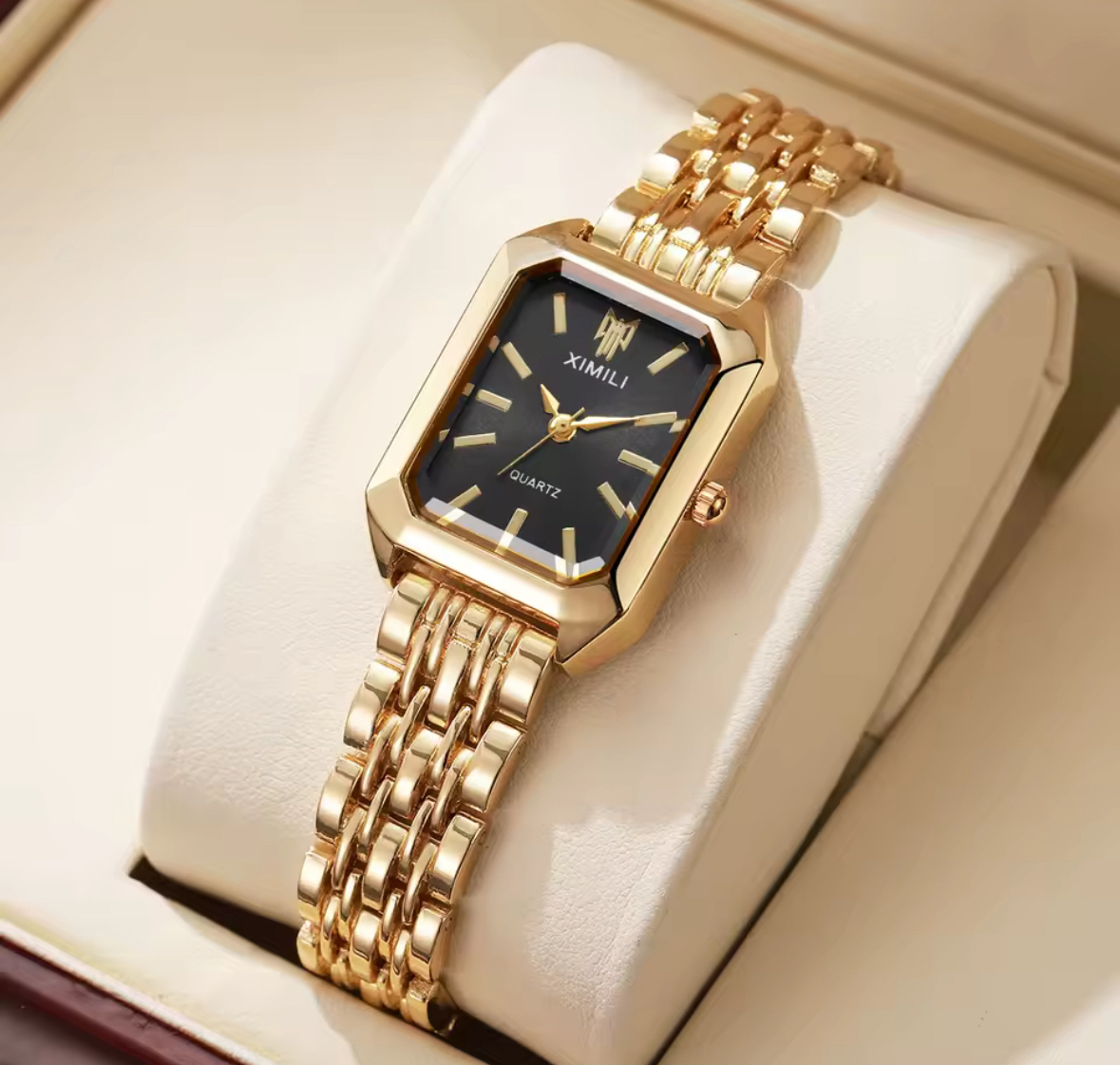 Black dial XIMILI watch on a cream cushion